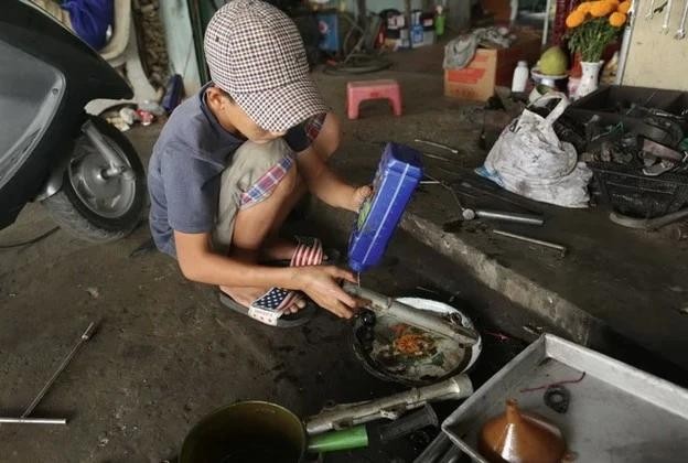一名街头少年学习维修摩托车。（图：UNICEF）