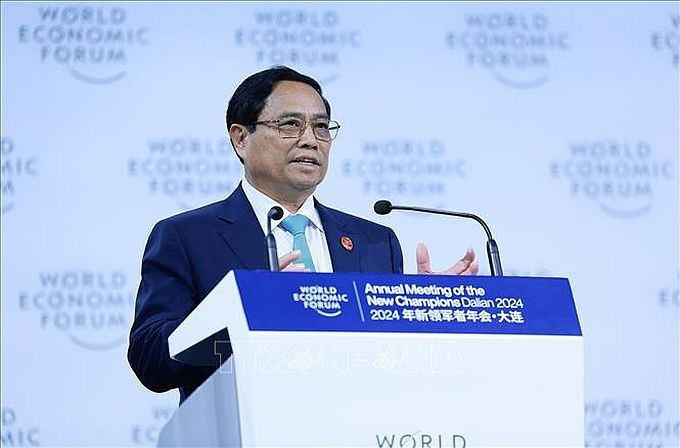越南政府总理范明政在世界经济论坛第十五届新领军者年会开幕式上发表特别讲话。(图:越通社) TTG (1).jpg