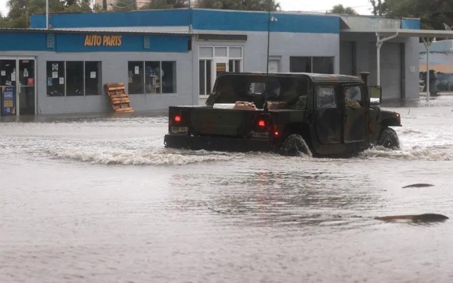 当地时间5日在佛罗里达州锡达礁，一辆国民警卫队车辆驶过一条由被洪水淹没的街道。（图：AFP）