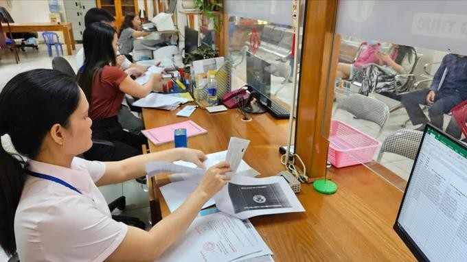 旧邑郡第一坊人委会公务员正在为民众处理证件。