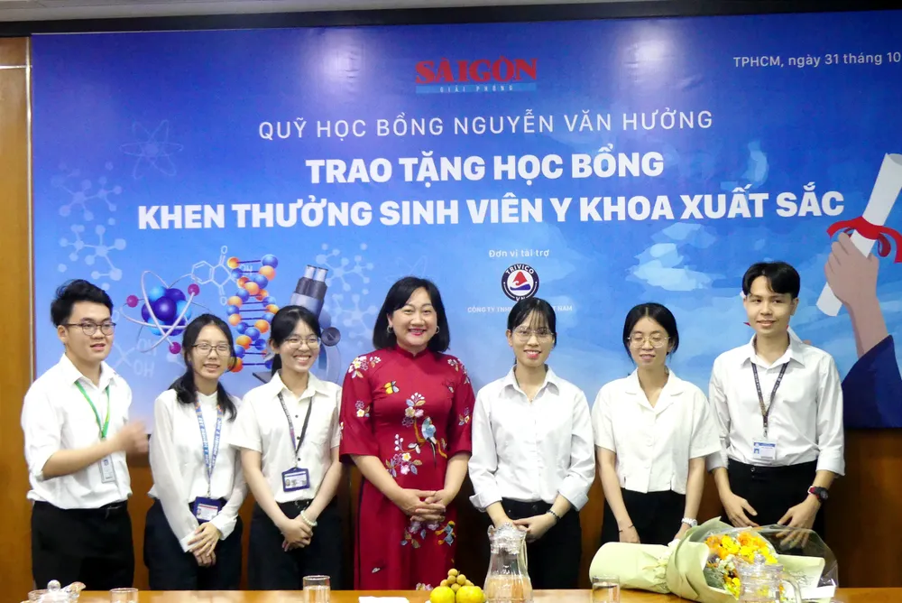 Phó Tổng Biên tập Báo Sài Gòn Giải Phóng Bùi Thị Hồng Sương chụp ảnh lưu niệm cùng 6 sinh viên y khoa xuất sắc