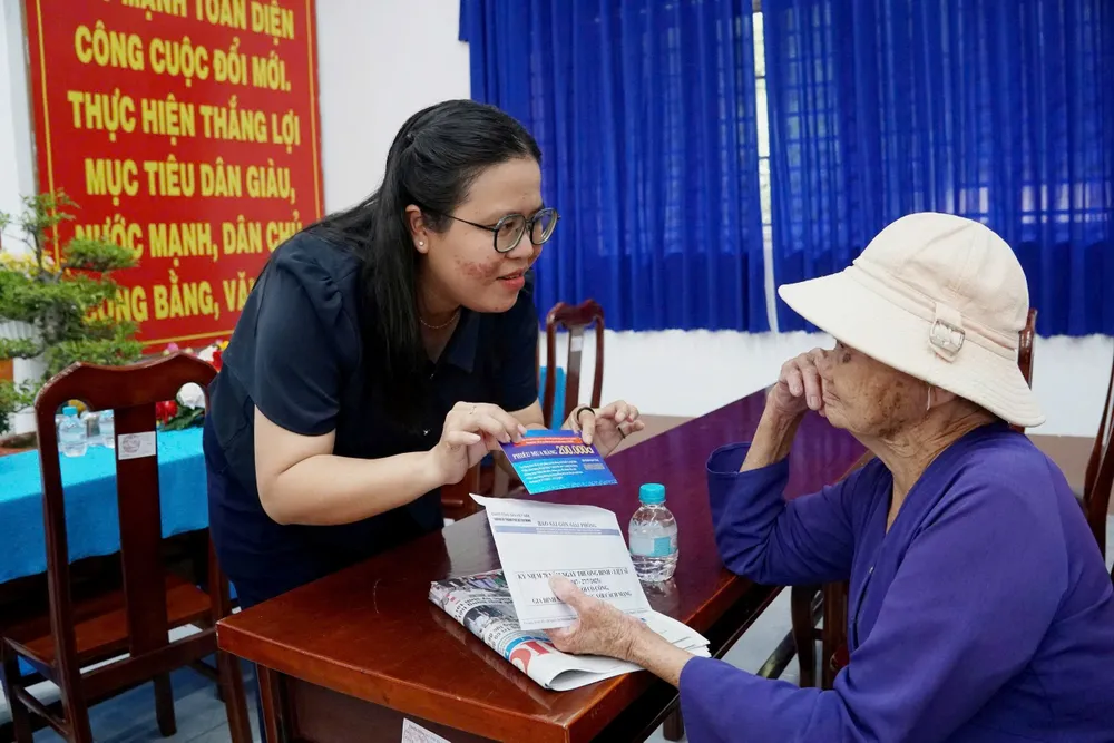 Ban tổ chức hướng dẫn bà con sử dụng phiếu quà tặng mua hàng tại xã Đông Thạnh. Ảnh: VIỆT NGA z6850220854726_1f4643e0205c80861ff07d2e28e7697c.jpg