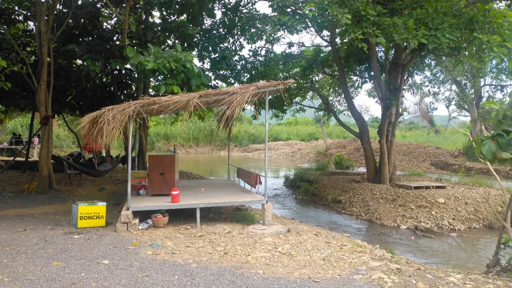 Đối diện khu sinh thái nhà vườn Tiến Đạt còn có một điểm du lịch khác cũng dựng lều, chòi kinh doanh bên bờ sông Cái