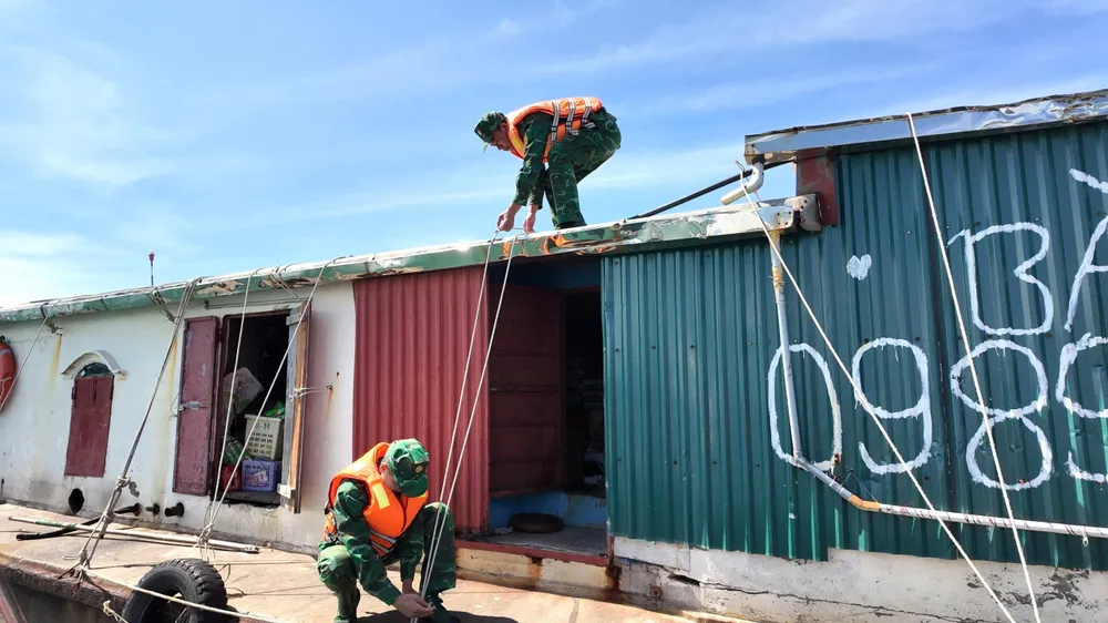 Bộ đội Biên phòng Quảng Ninh giúp người dân gia cố tàu thuyền để phòng chống bão số 9. Ảnh: THU BÁU z7044388524402_63fac9f3425514af54d33747614ab5b5.jpg
