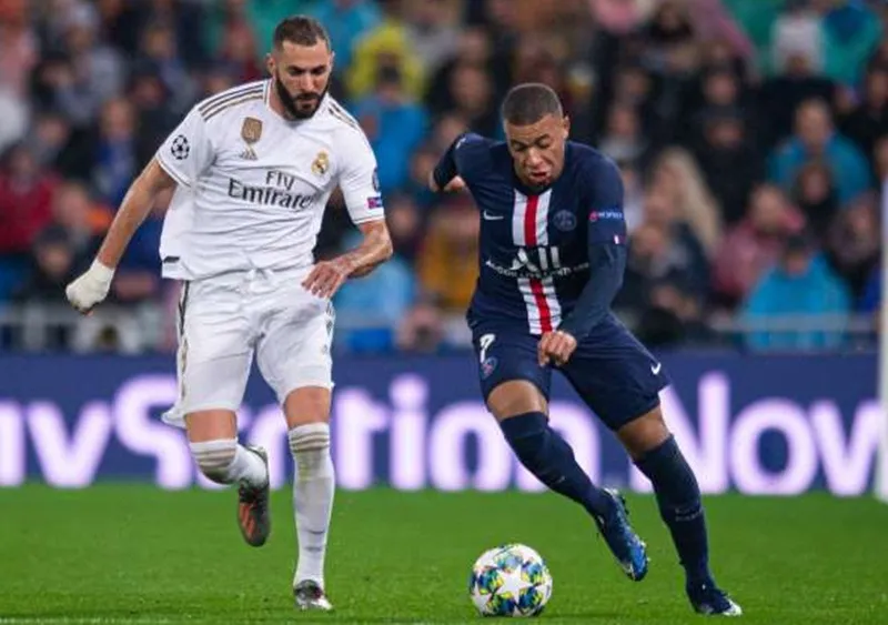 Kylian Mbappe (phải) cùng Paris SG đối đầu Real Madrid ở vòng bảng Champions League. Ảnh: Getty Images