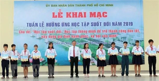 Các em học sinh được nhận học bổng khuyến học tại chương trình. Ảnh: TTXVN