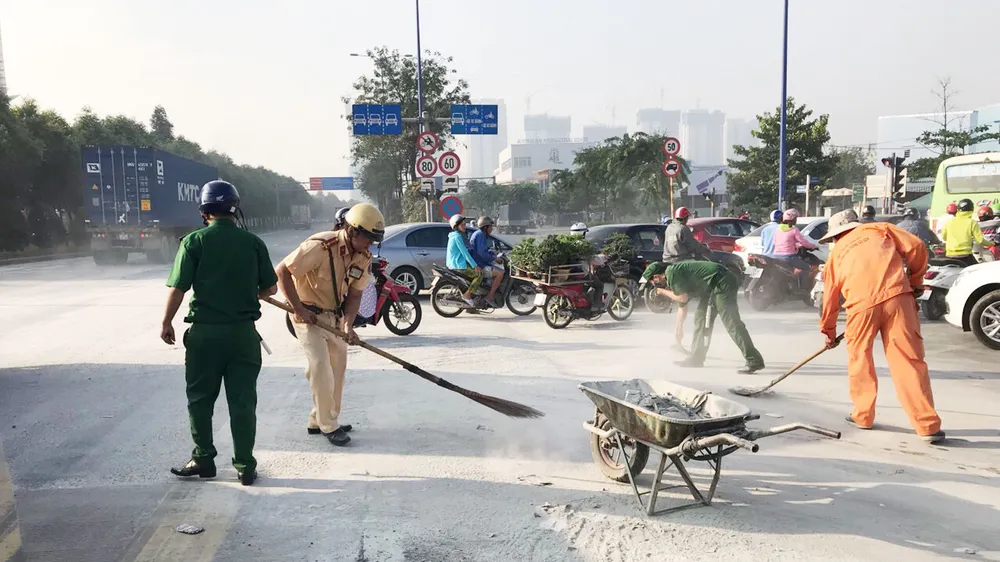 Hình ảnh đẹp của CSGT TPHCM thu dọn bùn đất rơi trên đường phố ảnh 3