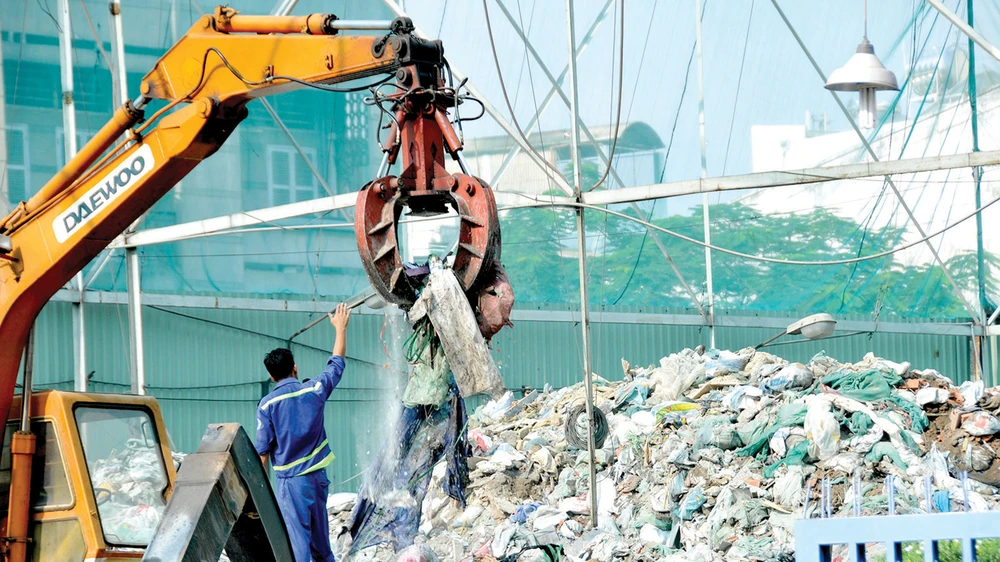  Thu gom chất thải rắn sinh hoạt tại trạm trung chuyển trên đường Lê Đại Hành, quận 11, TPHCM. Ảnh: CAO THĂNG