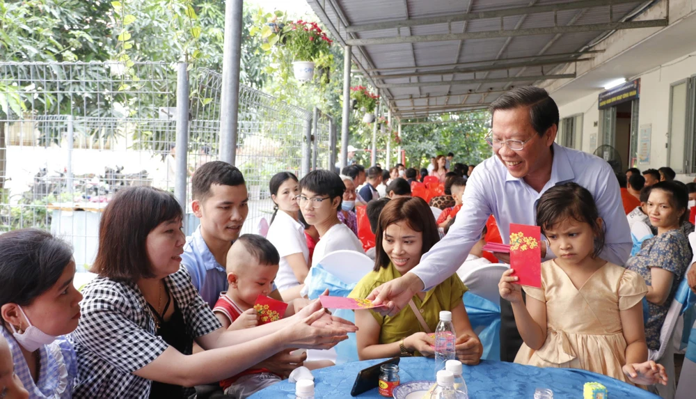 Chủ tịch UBND TPHCM Phan Văn Mãi lì xì công nhân không về quê ăn tết tại khu lưu trú công nhân, Khu Công nghiệp Hiệp Phước, huyện Nhà Bè. Ảnh: NGÔ BÌNH