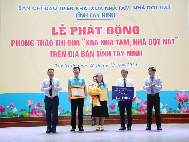 Công ty Cổ phần xi măng Fico Tây Ninh ủng hộ Chương trình xóa nhà tạm, nhà dột nát tỉnh Tây Ninh 5,2 tỷ đồng. Ảnh: TTXVN