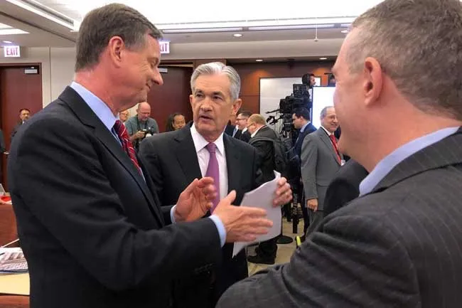 Federal Reserve Chairman Jerome Powell (C) speaks with Chicago Fed President Charles Evans (L) and St Louis Fed President James Bullard at a conference on monetary policy at the Federal Reserve Bank of Chicago, part of a 'Fed Listens' series as the U.S. c
