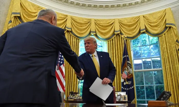 Chinese Vice Premier Liu He (L) hands over a letter of Chinese leader Xi Jinping to President Donald Trump at the Oval Office of the White House in Washington, on Oct. 11, 2019 (NICHOLAS KAMM/AFP via Getty Images)