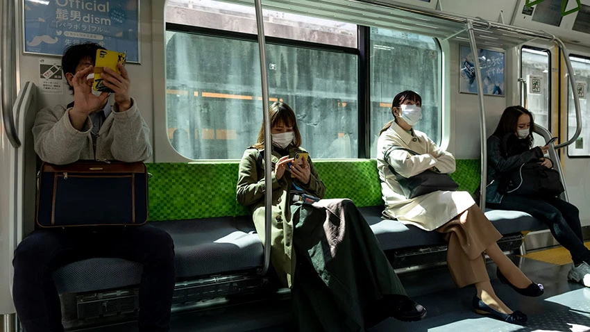 Social distancing on a commuter train in Japan. Tokyoites will have to limit their time outside to 110 minutes per week, if a Yokohama City University professor's calculations are right. © AP