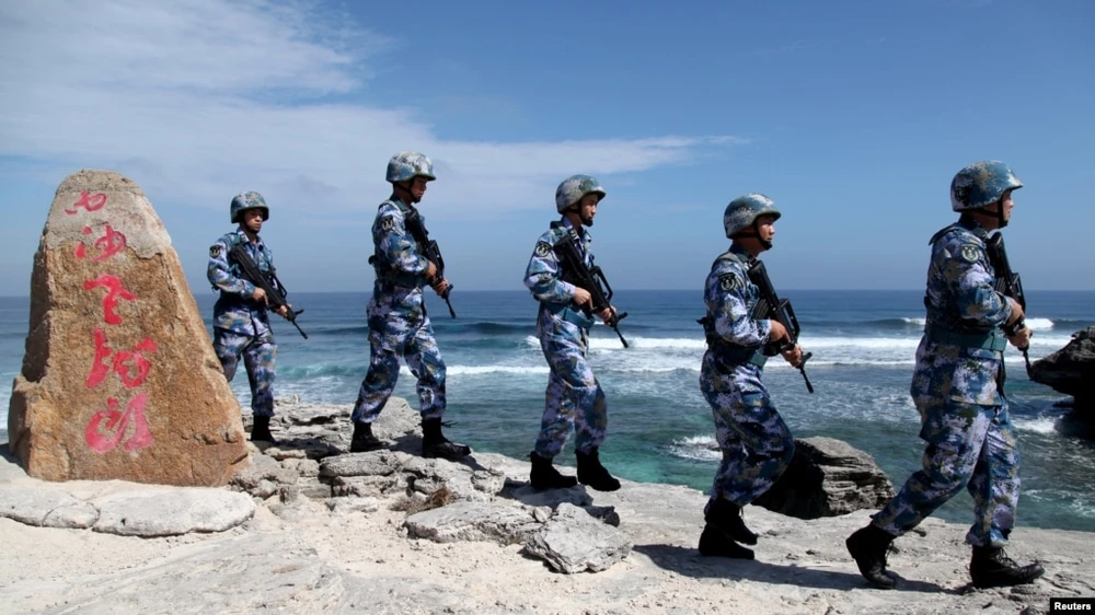 Soldiers of China's People's Liberation Army (PLA) Navy patrol Woody Island in the Paracel archipelago on January 29, 2016.