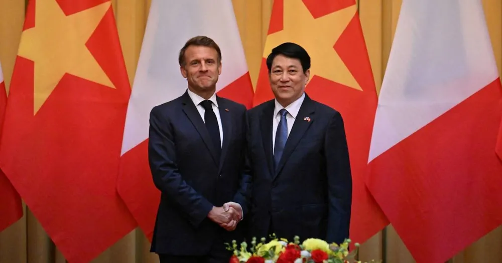 France's President Emmanuel Macron and Vietnam's President Luong Cuong shake hands during a meeting at the Presidential Palace in Hanoi on May 26, 2025.