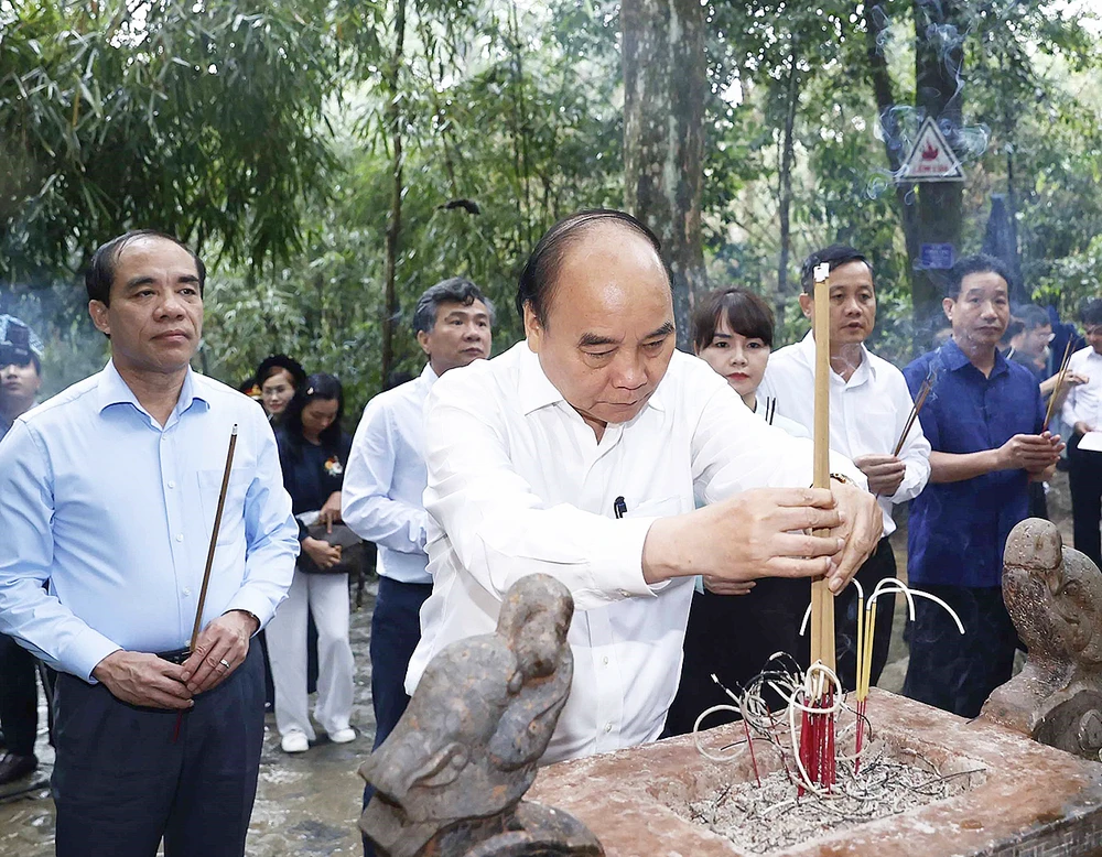 Chủ tịch nước Nguyễn Xuân Phúc cùng đoàn công tác dâng hương tưởng nhớ Chủ tịch Hồ Chí Minh tại lán Nà Nưa trong Khu di tích lịch sử quốc gia đặc biệt Tân Trào. Ảnh: TTXVN