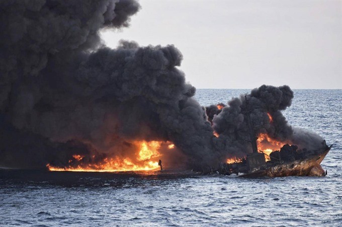 This handout picture from China’s Transport Ministry taken and released on January 13, 2018 shows smoke and flames coming from the burning oil tanker. — AFP/VNA Photo