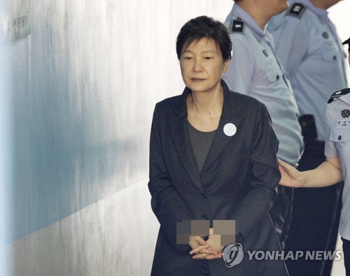 Court sentences ex-leader Park to 8 years in prison...