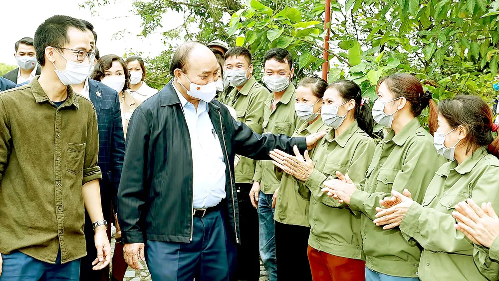 Chủ tịch nước Nguyễn Xuân Phúc với các xã viên Hợp tác xã Sinh Dược, xã Gia Sinh, huyện Gia Viễn, tỉnh Ninh Bình. Ảnh: TTXVN