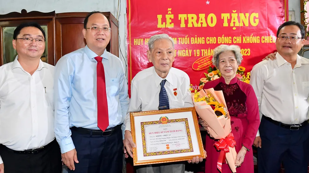 Phó Bí thư Thành ủy TPHCM Nguyễn Hồ Hải trao Huy hiệu 65 năm tuổi Đảng cho đồng chí Khổng Chiêu Lư. Ảnh: VIỆT DŨNG