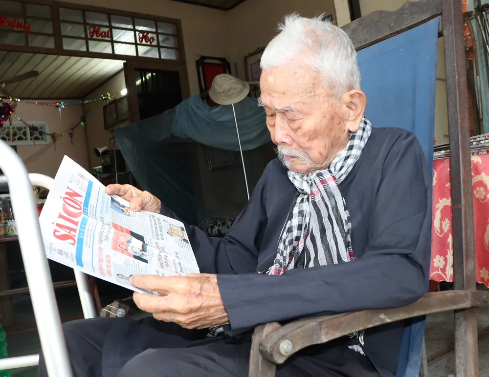 Ở tuổi 100, ông Hai Hỷ vẫn đọc báo vào mỗi buổi sáng. Ảnh: THÁI PHƯƠNG Ở tuổi 100, ông Hai Hỷ vẫn đọc báo vào mỗi buổi sáng. Ảnh: THÁI PHƯƠNG