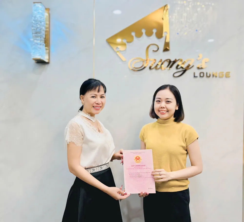 Bà Võ Thu Sương (bên trái) tặng sổ đỏ chị Huỳnh Thị Bảo Yến anh-1-2089.jpg