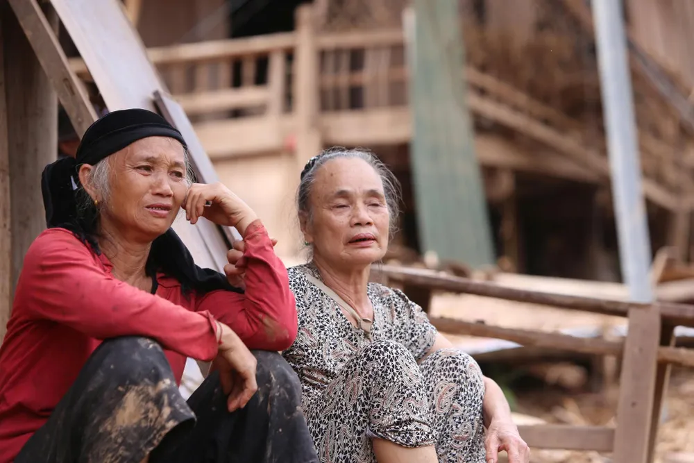 Bà Vi Thị Hồng (bên phải, 72 tuổi, trú bản Xiềng Tắm) khóc nức nở khi toàn bộ tài sản, nhà cửa bị cuốn bay sau trận lũ dữ. Ảnh: Hồ Văn Ngợi 522749648_1494859978355324_6591326640944564842_n.jpg