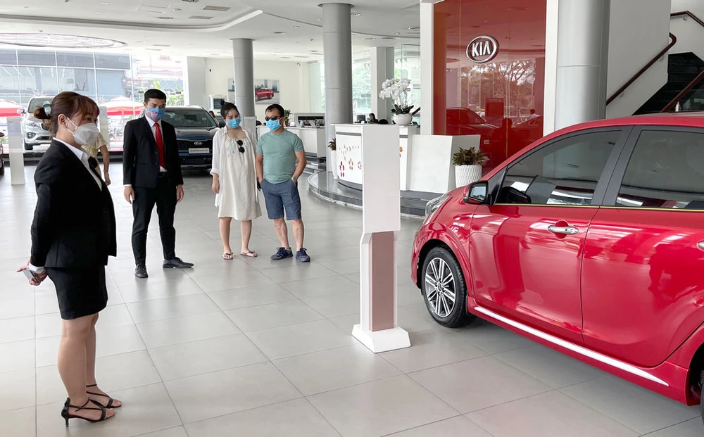 Người dân đi xem xe lắp ráp trong nước tại showroom KIA Phú Mỹ Hưng Ảnh: HOÀNG HÙNG