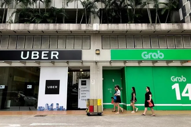 Singapore đưa ra biện pháp hạn chế tạm thời thương vụ Grab-Uber