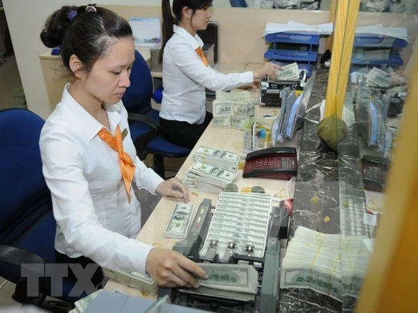 Hơn 70% người dân nhận kiều hối chuyển sang VND. (Ảnh: Vietnam+)