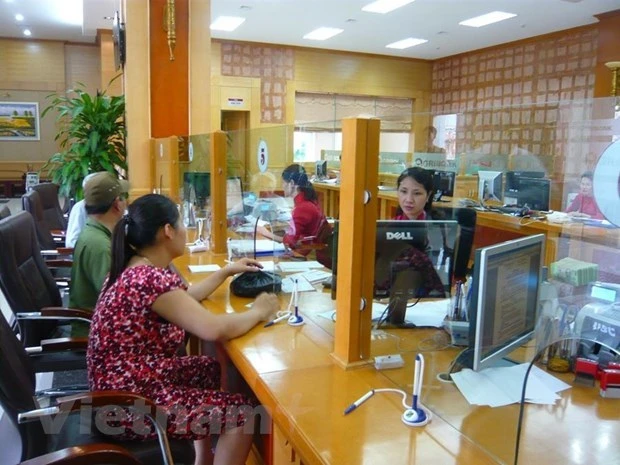 Giao dịch tại Agribank. (Ảnh: Thúy Hà/Vietnam+)