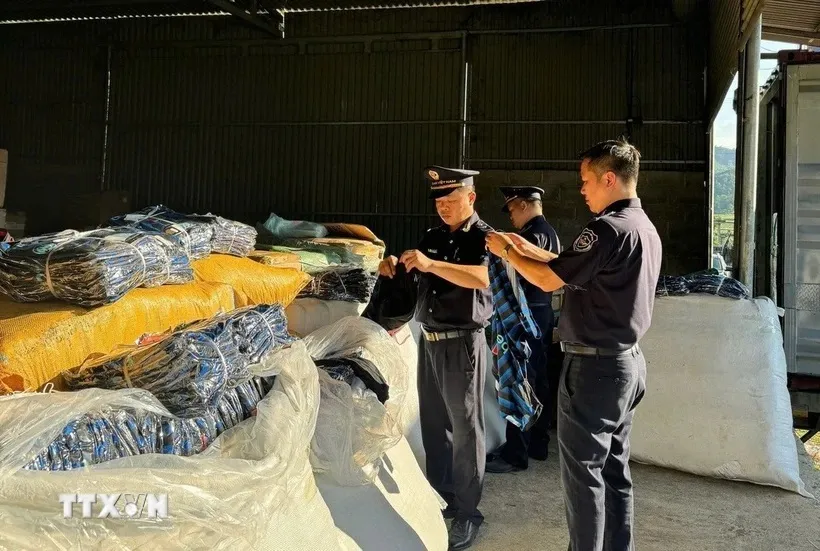 Lực lượng Hải quan kiểm tra lô hàng nhái bị thu giữ. (Ảnh TTXVN phát)