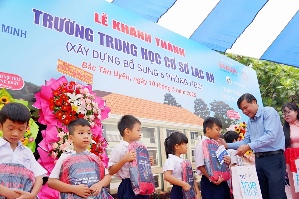 Đồng chí Tăng Hữu Phong tặng quà động viên các em học sinh. Ảnh: VIỆT NGA nnn.jpg