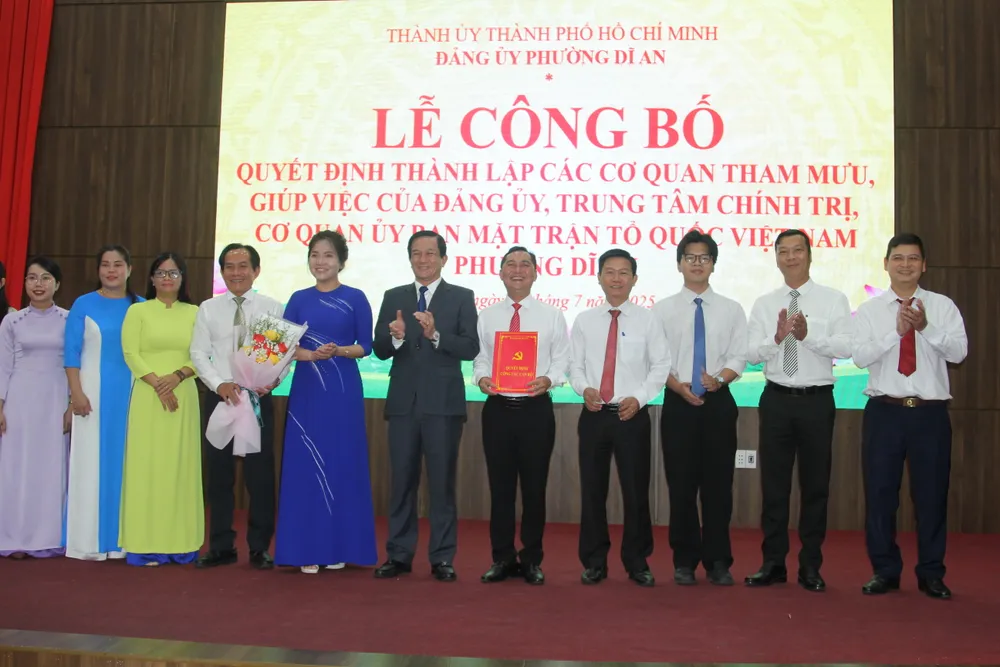 Bí thư Đảng ủy, Chủ tịch UBND phường Dĩ An trao quyết định và chúc mừng các nhân sự nhận nhiệm vụ. Ảnh: XUÂN TRUNG IMG_0185.JPG
