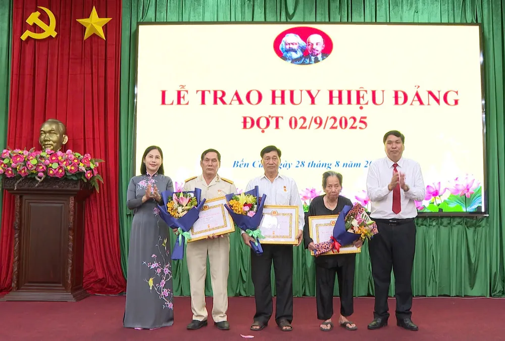 Phó Bí thư Đảng ủy, Chủ tịch UBND phường Bến Cát Trần Thị Thảo cùng lãnh đạo phường trao Huy hiệu Đảng cho các đảng viên z6952683330796_bcc530f842e1bcfd151da87aa1ea0f1e.jpg