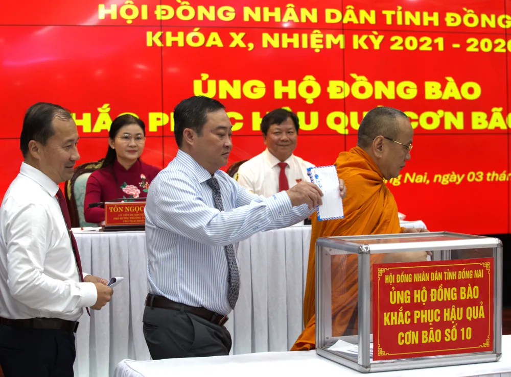 Các đại biểu ủng hộ đồng bào bị ảnh hưởng bão lũ. Ảnh: VĂN PHONG ok.jpg