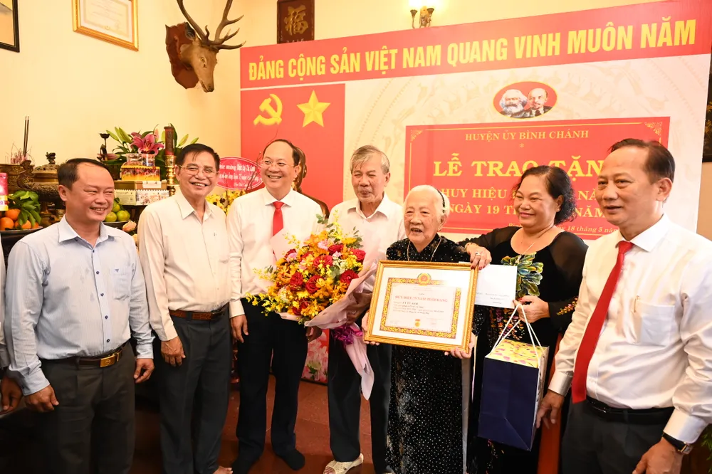 Phó Bí thư Thành ủy TPHCM Nguyễn Hồ Hải trao Huy hiệu 75 năm tuổi Đảng đến đồng chí Lý Tú Anh. Ảnh: VĂN MINH