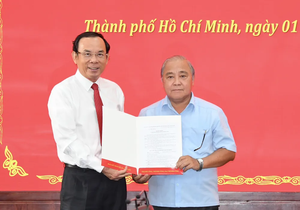 Bí thư Thành ủy TPHCM Nguyễn Văn Nên trao quyết định nghỉ hưu cho đồng chí Võ Văn Tân. Ảnh: VIỆT DŨNG