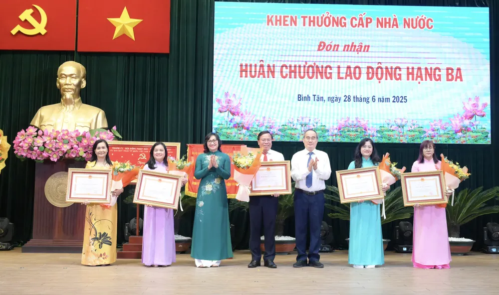 Đồng chí Nguyễn Thiện Nhân và đồng chí Phan Thị Thắng trao Huân chương Lao động hạng Ba cho các cá nhân. Ảnh: VĂN MINH DSC_0414.jpeg