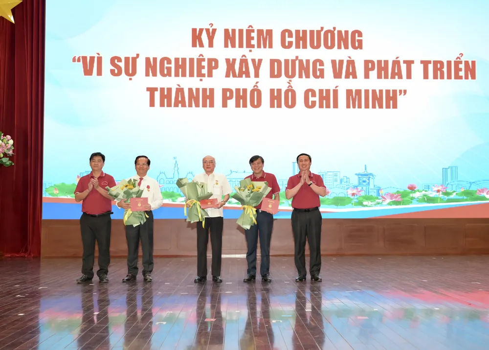 Đồng chí Lê Hoàng Hải và đồng chí Lê Văn Minh trao kỷ niệm chương và tặng hoa chúc mừng các cá nhân. Ảnh: VĂN MINH DSC_0682.jpeg