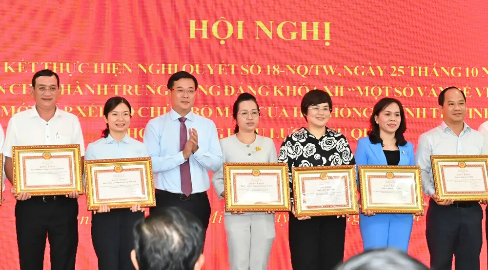 Đồng chí Lê Quốc Phong trao bằng khen cho các tập thể, cá nhân có thành tích xuất sắc trong việc thực hiện Nghị quyết 18. Ảnh: VIỆT DŨNG gen-h-z7143190803449_d747b482c40ef1c2eae8bac26017150d.jpg