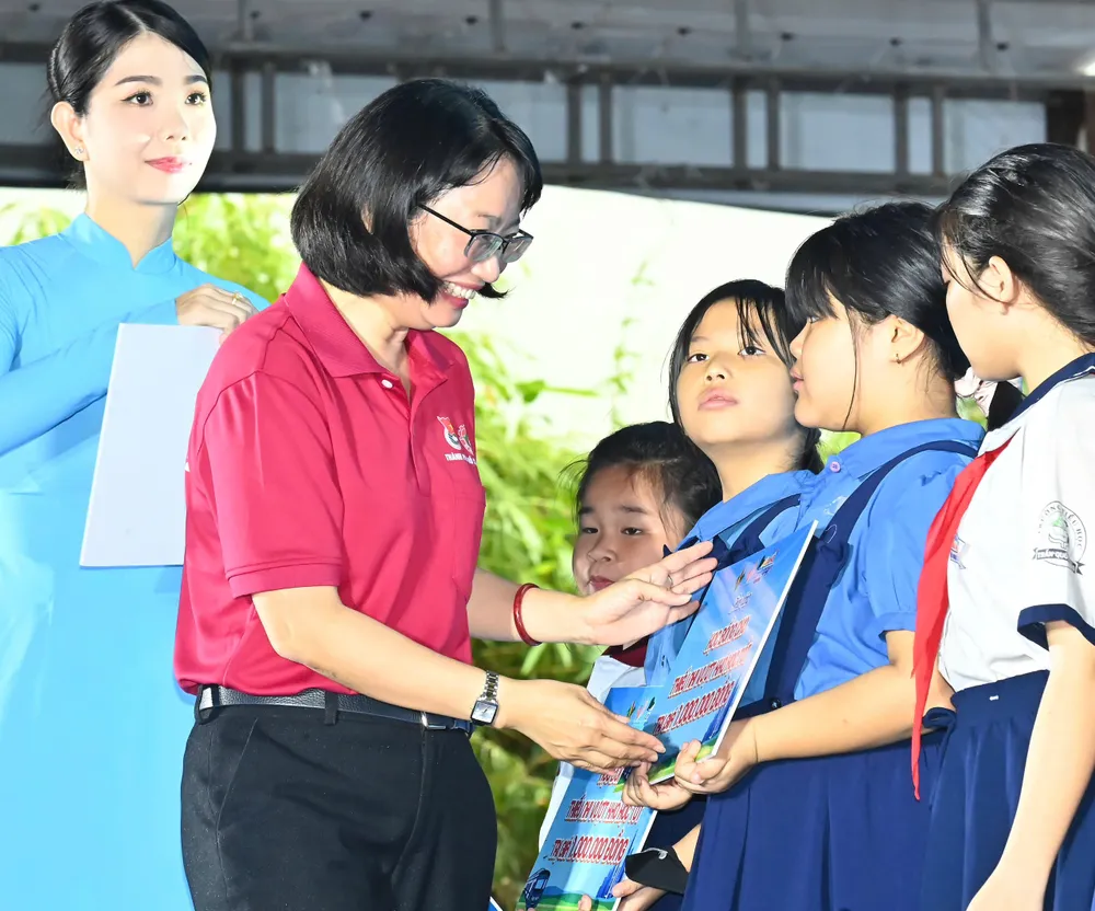 Đồng chí Trần Thị Diệu Thúy trao học bổng đến học sinh vượt khó học tốt. Ảnh: VIỆT DŨNG z6752977740517_4e807a2551ba04f5b48c6a15d41b452f.jpg