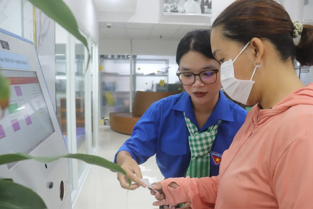Người dân được tình nguyện viên hỗ trợ tại Trung tâm Phục vụ hành chính công phường Xuân Hòa z6779712386289_3fdfb72836d0fd8092a259308f773108.jpg