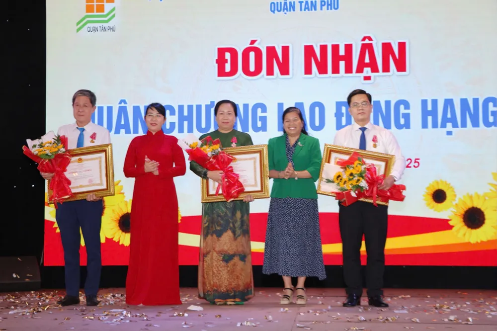 Phó Giám đốc Sở Nội vụ TPHCM Nguyễn Thị Hồng Thắm (áo xanh) cùng Bí thư Quận ủy Tân Phú Lê Thị Kim Hồng trao Huân chương Lao động cho các cá nhân thuộc quận Tân Phú bec2f28e901e24407d0f.jpg