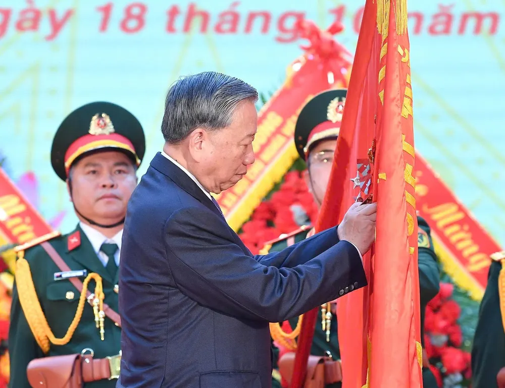 Tổng Bí thư Tô Lâm gắn Huân chương Hồ Chí Minh lên lá cờ truyền thống của Tổng cục II, Bộ Quốc phòng, sáng 18-10. Ảnh: VIẾT CHUNG z7129373293067_8e4f534ff5459d1b92b3853702b98392.jpg