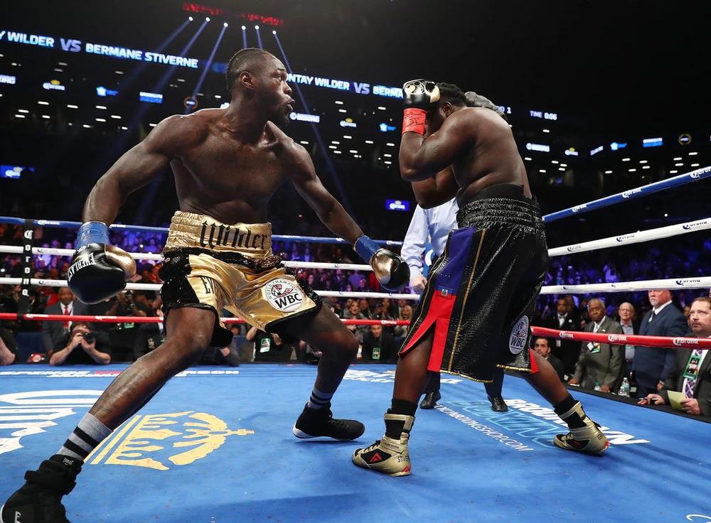 Deontay Wilder (trái) lao vào Bermane Stiverne như "hổ đói vồ mồi"