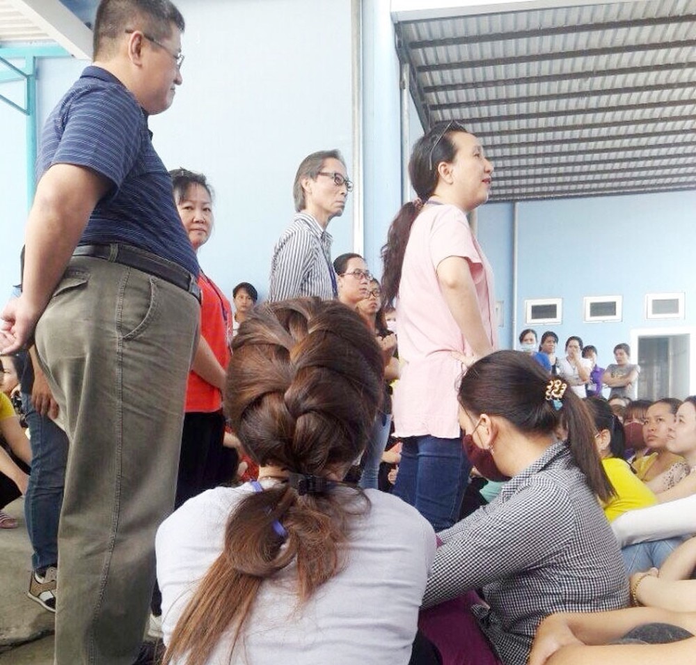 HDI負責人與罷工的工人們商討解決勞動合同糾紛事宜。（圖片來源：互聯網）