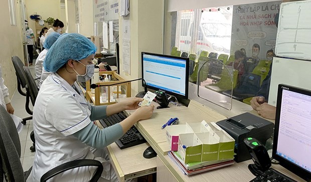 Nearly 12,270 medical units, accounting for 96 percent of the total across the country, have accepted the chip-based ID cards which are integrated with health insurance cards for their services.(Photo: VNA)