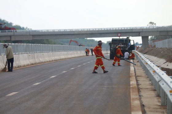 Workers clean up the road before the opening date.