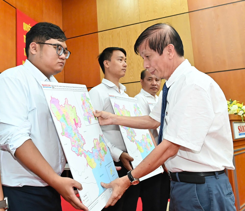 Mr. Nguyen Khac Van, Deputy Editor-in-Chief in charge of Sai Gon Giai Phong Newspaper, presents administrative maps to representatives of wards and communes. 7-7-8-3960-6391.jpg.jpg